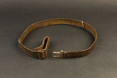 a close up of a belt with a metal buckle on a table