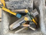 a bucket full of tools that are sitting on the ground