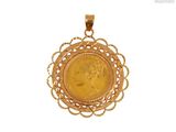 a close up of a gold coin in a pendant on a white background