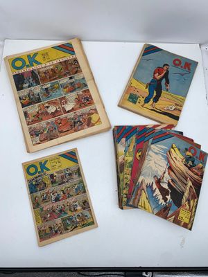 several comics are on display in a box on a table