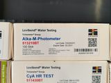 three boxes of water testing equipment sitting on top of a table