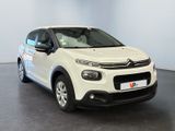 a white citrole parked in a room with a black floor