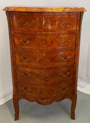 an old wooden chest of drawers with a marble top