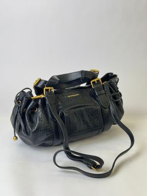 a black leather purse with a gold chain strap