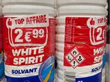 several bottles of white and red liquid sitting on top of a counter