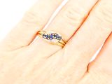an image of a woman ' s hand with a ring on it