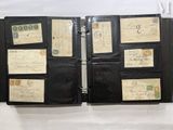 a black folder with a lot of old stamps on it