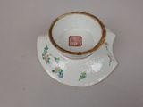 a small cup and saucer on a white table