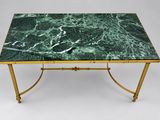 a green marble top coffee table with brass legs