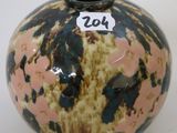 a small vase with a number on it sitting on a table