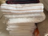 towels stacked on top of each other on a bed in a room
