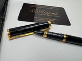 a pen and a business card sitting on a table