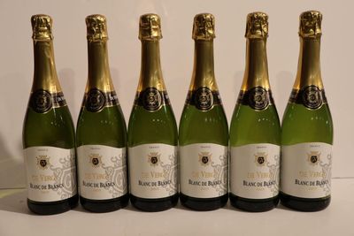 six bottles of champagne are lined up on a table
