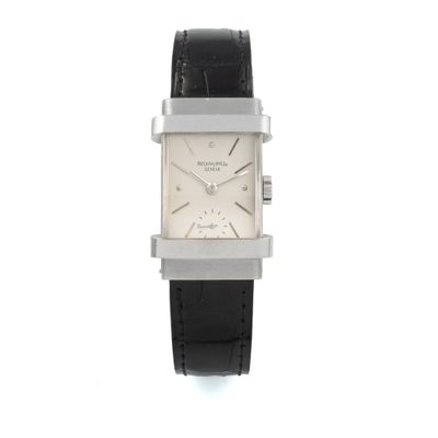 an image of a white square watch with a black leather strap