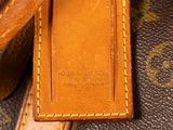 a close up of a louis vuitton bag on a table