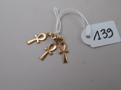 a gold keychain with an ankht and an ankht on it