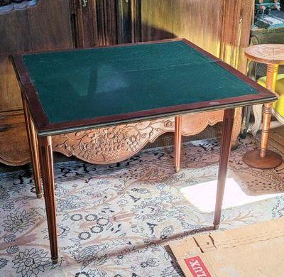 a small table with a green top in a room