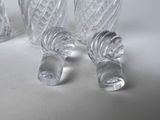 three clear glass vases sitting next to each other on a white surface