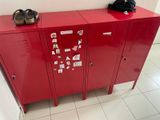 a red locker with a pair of shoes on top of it