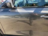 a reflection of a man riding a skateboard on the side of a car