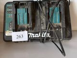 two makita batteries that are connected to a charger