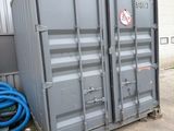 a large gray container sitting outside of a building