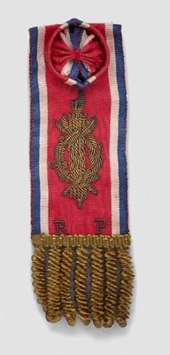 a red, white, and blue scarf with a crest on it