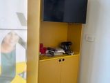 a yellow cabinet with a television on top of it