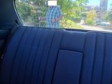 a man that is standing in the back seat of a car