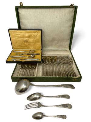 a green case with silverware in it on a white surface