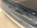 a close up of a car ' s bumper with scratches on it