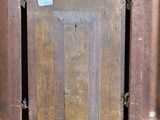 a picture of an old wooden door with a blue sticker on it