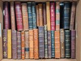 a box full of old books sitting on the floor