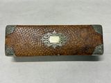 a close up of a leather case on a table