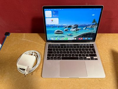 a laptop computer sitting on top of a wooden table