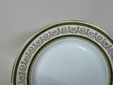 a close up of a plate with a gold border