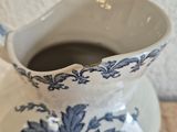 a blue and white pitcher sitting on a table