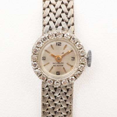 an image of a woman ' s wrist watch with a diamond bezel