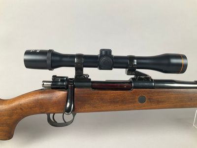 a rifle with a scope mounted on top of it