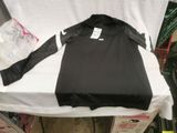 a black shirt sitting on a white table with a price tag on it