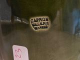 a close up of a green vase with a sticker on it