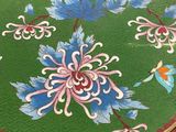 a round table with a painted flower design on it