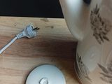 a tea pot and a mouse on a wooden table
