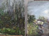 paintings of trees and bushes are displayed on easels in front of a window