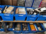 boxes of assorted items are stacked on a shelf in a room