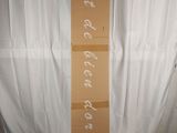 a cardboard box with writing on it sitting on a bed