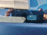 a reflection of a person in the rear view mirror of a car