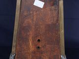 an old wooden clock with a metal frame on a blue background