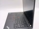 a laptop with a black keyboard on a white surface