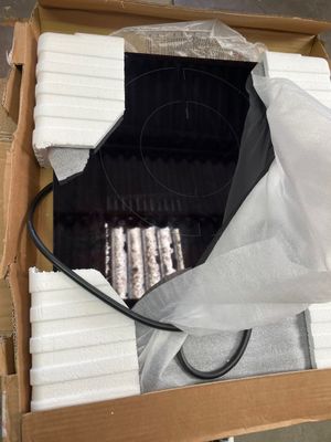 a box with a bunch of white candles inside of it